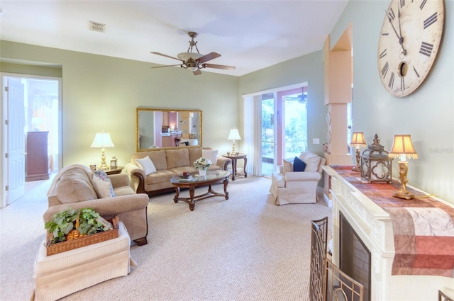 living room with ceiling fan and light colored carpet