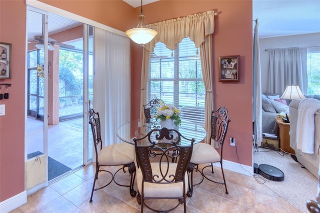 tiled dining space featuring ceiling fan and a healthy amount of sunlight