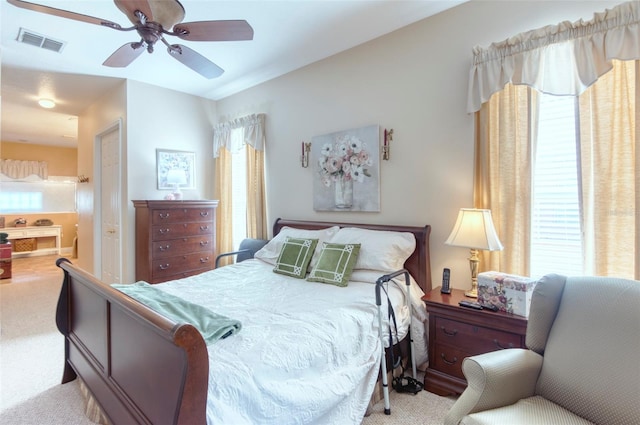 bedroom featuring light carpet and ceiling fan