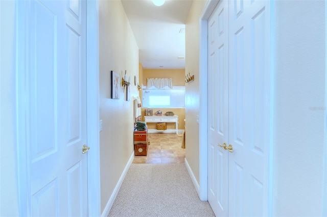 hall featuring light tile patterned floors