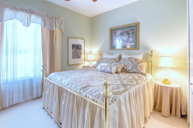 bedroom featuring ceiling fan and light carpet