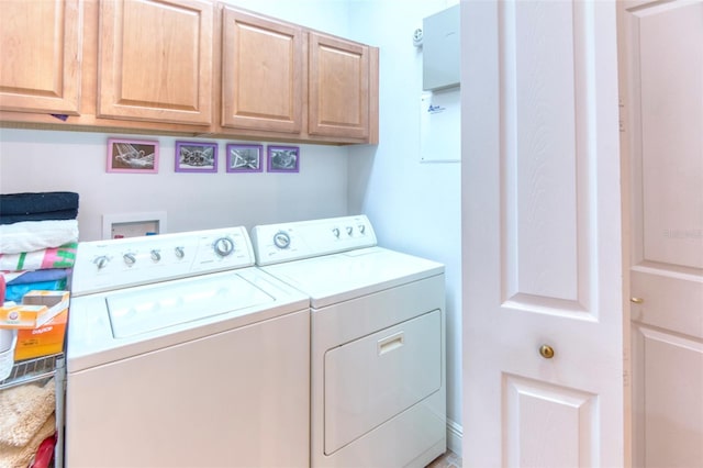 laundry room with washing machine and dryer and cabinets