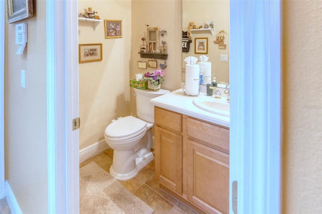 bathroom featuring tile patterned floors, vanity, and toilet