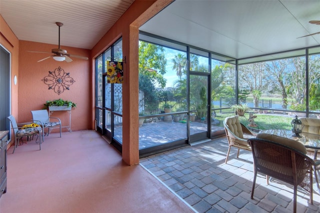 sunroom with a wealth of natural light and ceiling fan