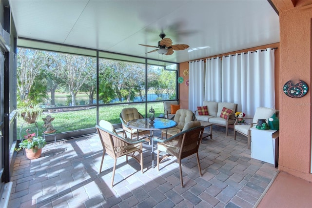 sunroom / solarium featuring ceiling fan and a healthy amount of sunlight