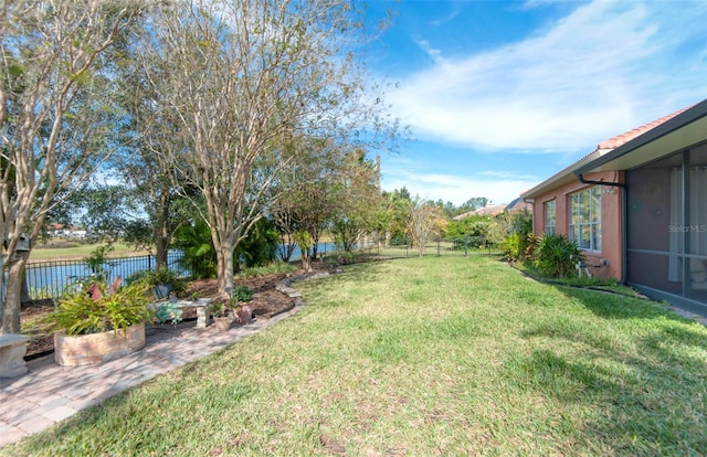 view of yard with a water view and a patio