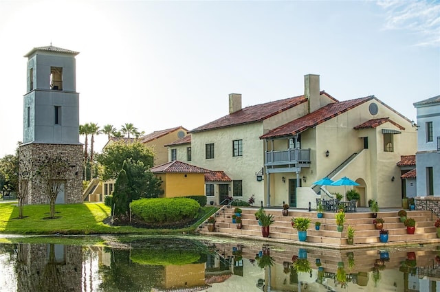 rear view of property featuring a balcony