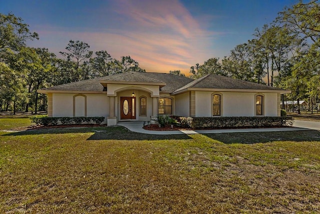 view of front of house with a yard