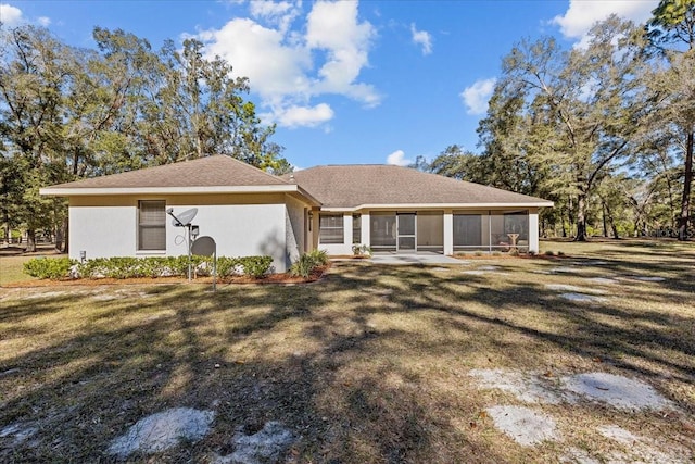 ranch-style home with a sunroom and a front yard