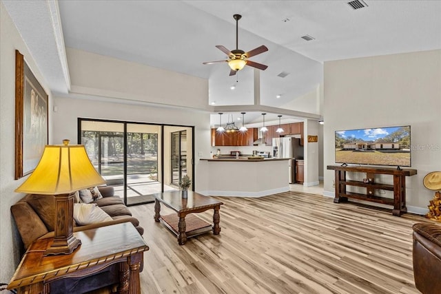 living room featuring ceiling fan, high vaulted ceiling, and light hardwood / wood-style floors