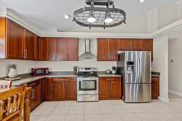 kitchen with light tile patterned flooring, wall chimney exhaust hood, stainless steel appliances, and lofted ceiling