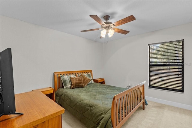 bedroom featuring ceiling fan and light carpet