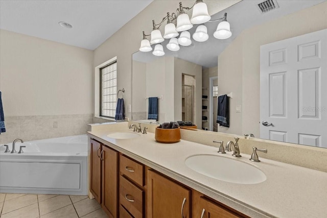 bathroom featuring tile patterned flooring, vanity, and a washtub