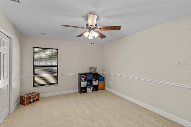 miscellaneous room featuring ceiling fan and light colored carpet