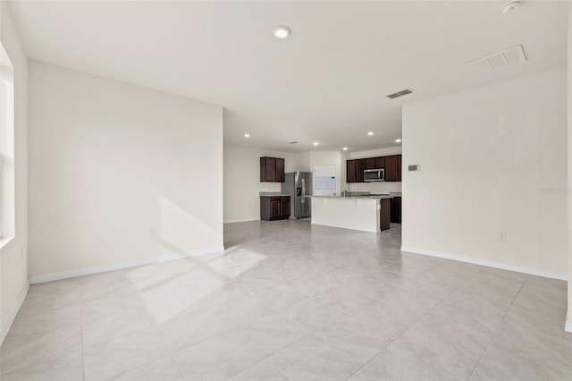 unfurnished living room featuring light tile patterned flooring