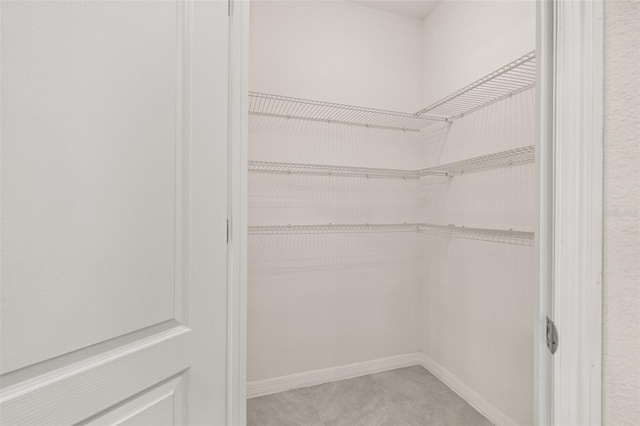 spacious closet featuring tile patterned floors