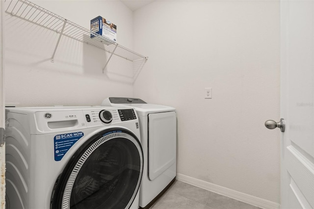 washroom with washer and dryer and light tile patterned flooring