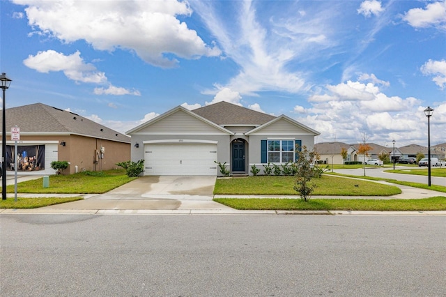 ranch-style house with a garage and a front lawn