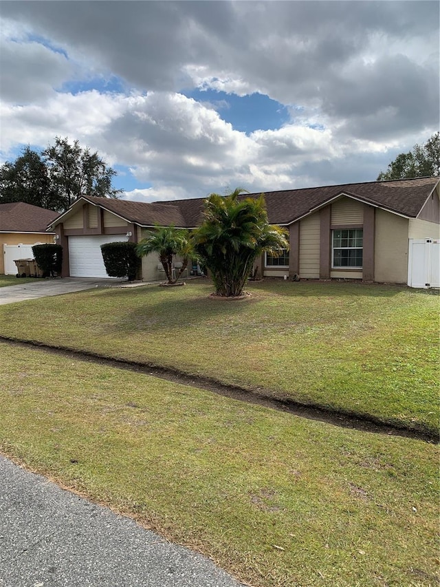 ranch-style home with a front yard and a garage