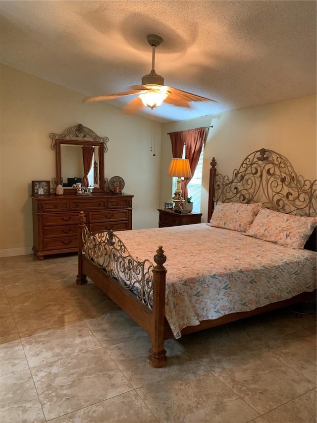 bedroom with a textured ceiling and ceiling fan