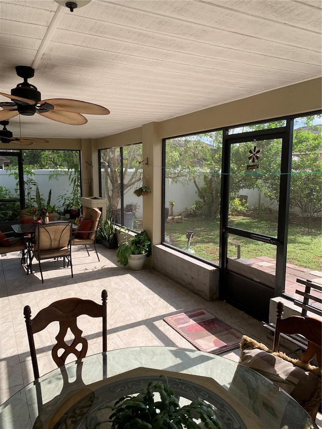 sunroom featuring ceiling fan