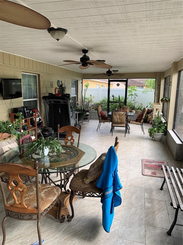 sunroom / solarium featuring ceiling fan