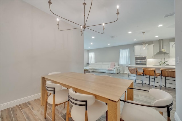 dining space with light wood-style floors, baseboards, visible vents, and recessed lighting