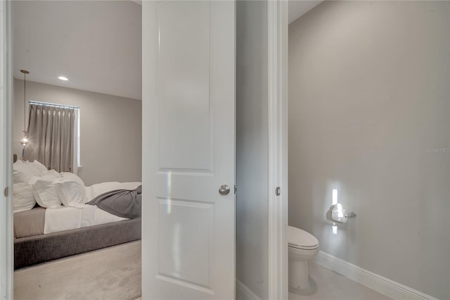 bathroom with toilet and baseboards