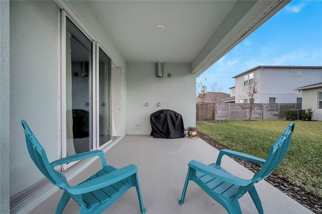 view of patio / terrace with a grill and fence