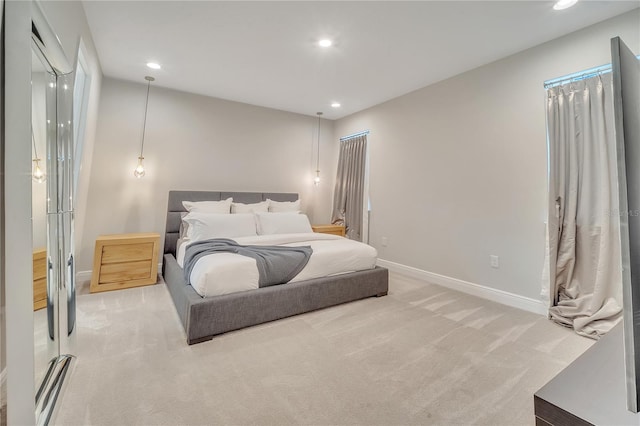 bedroom with recessed lighting, baseboards, and light colored carpet