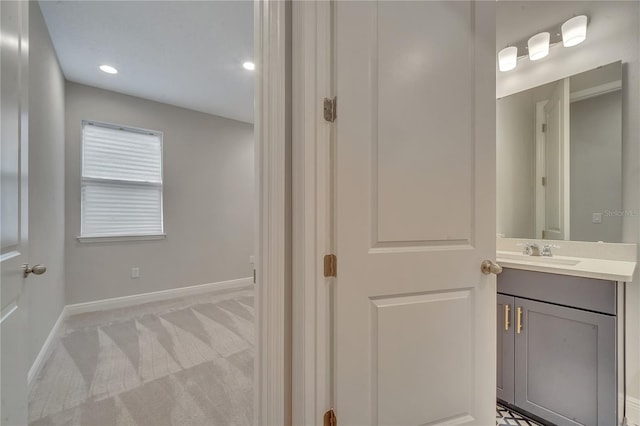 bathroom featuring recessed lighting, baseboards, and vanity