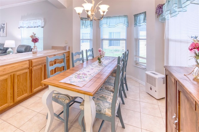 tiled dining area with crown molding and a notable chandelier