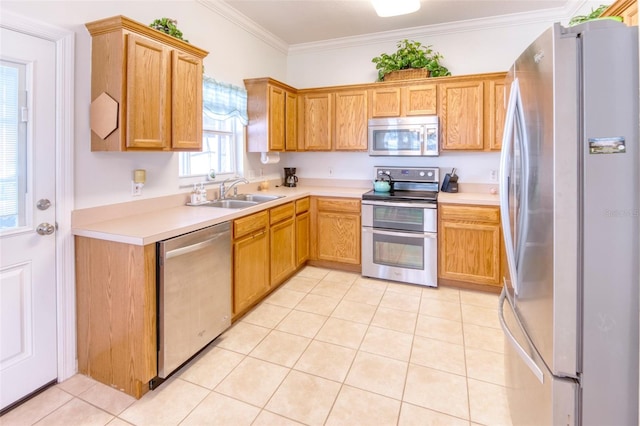 kitchen with appliances with stainless steel finishes, light tile patterned floors, ornamental molding, and sink