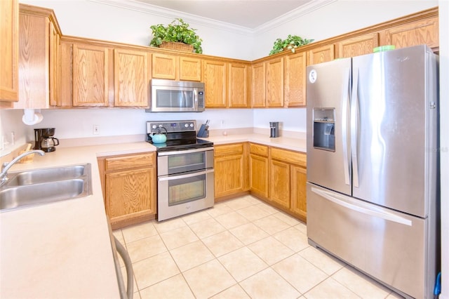 kitchen featuring light tile patterned flooring, sink, ornamental molding, and stainless steel appliances