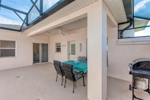 view of patio with ceiling fan, area for grilling, and a lanai