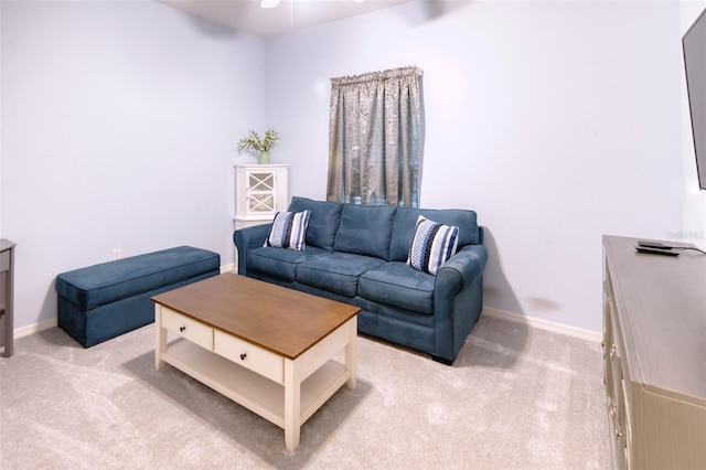 carpeted living room with ceiling fan