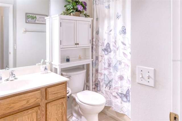 bathroom with tile patterned floors, curtained shower, vanity, and toilet