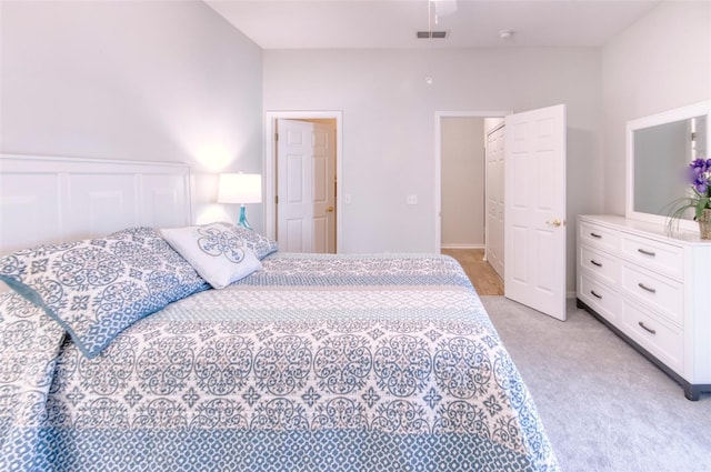 bedroom with light colored carpet and a closet