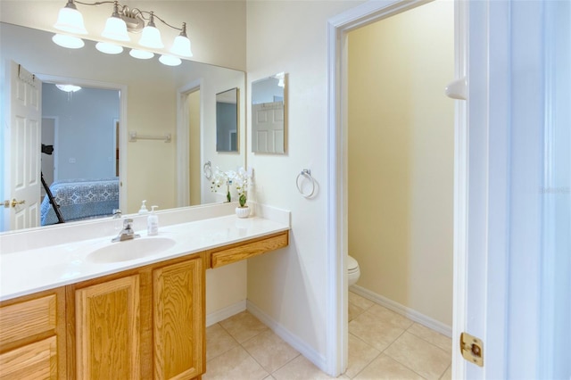 bathroom with tile patterned floors, vanity, and toilet