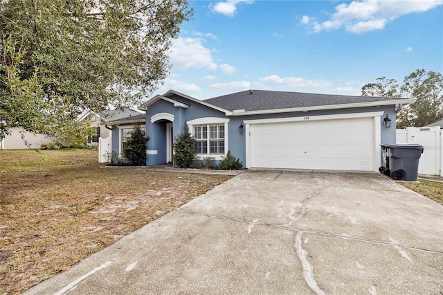 ranch-style house with a garage and a front lawn