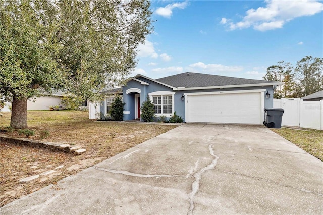 ranch-style home with a garage and a front yard