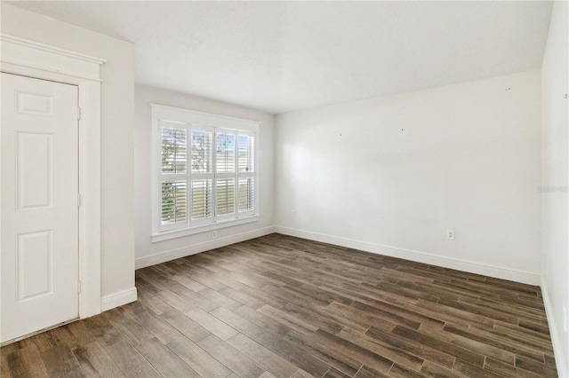 spare room featuring dark hardwood / wood-style floors