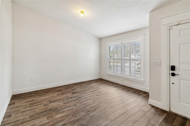 entryway featuring a textured ceiling and dark hardwood / wood-style flooring