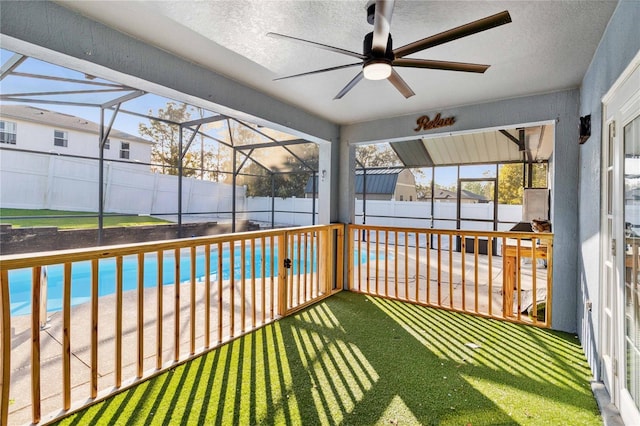 unfurnished sunroom with ceiling fan