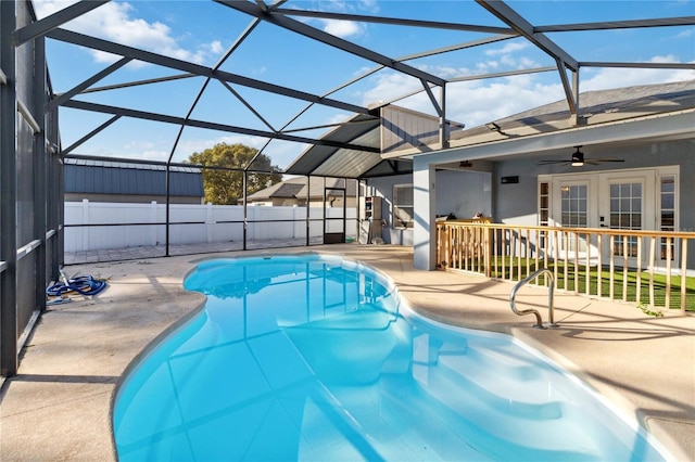 view of pool with french doors, ceiling fan, a patio area, and glass enclosure