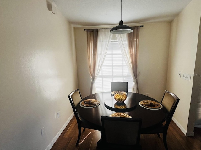 dining room with dark hardwood / wood-style flooring