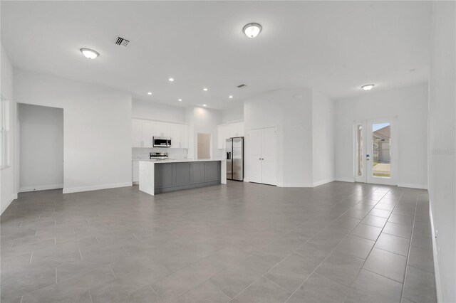 unfurnished living room with light tile patterned flooring