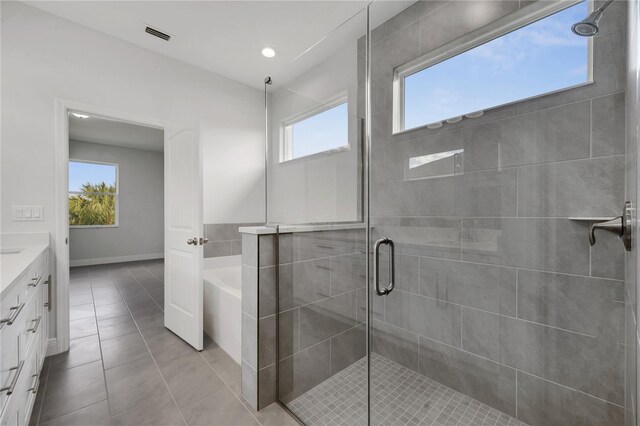 bathroom featuring tile patterned flooring, vanity, plenty of natural light, and shower with separate bathtub