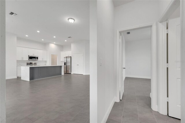 corridor featuring light tile patterned flooring