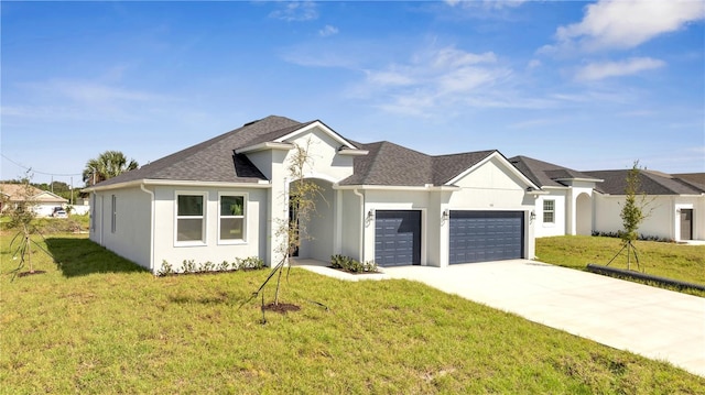 view of front of property with a garage and a front lawn